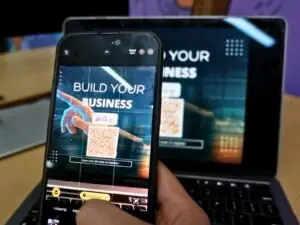 Video For Your Brand Video For Your Brand Blog A Person Holding A Cell Phone In Front Of A Laptop